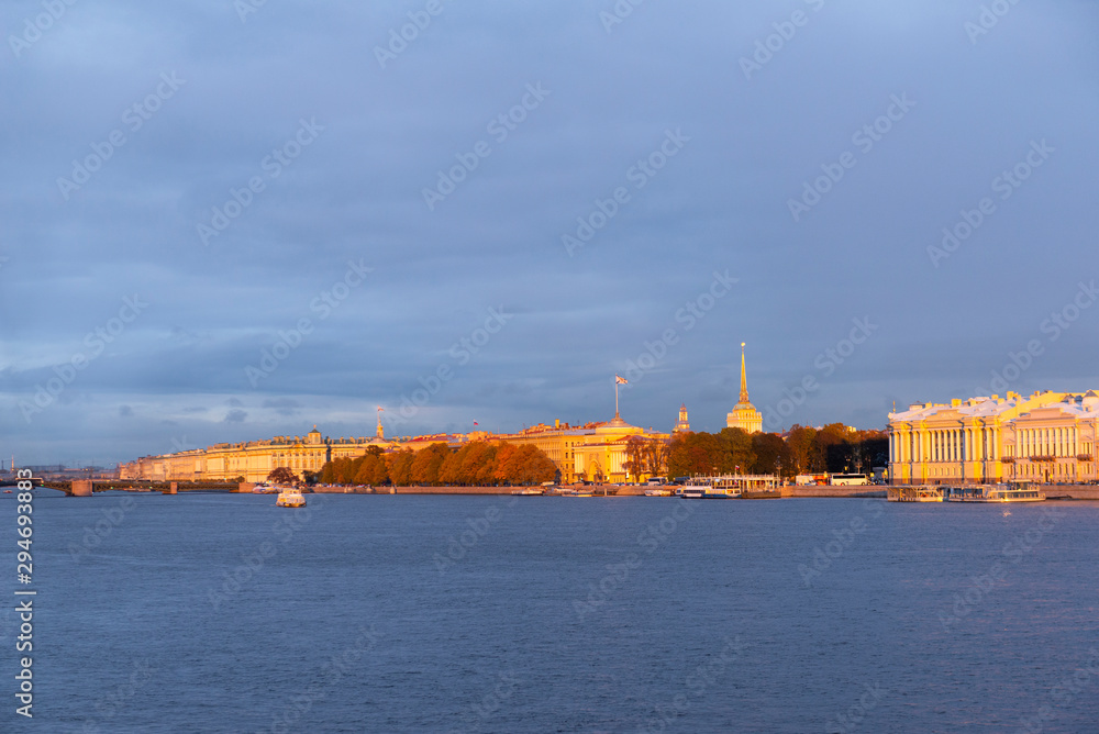 view of the Neva embankment in St. Petersburg at sunset in Golden sunlight, buildings on the shore