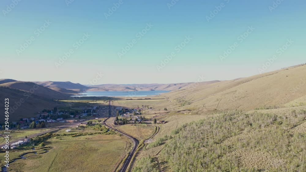 Aerial-Sundown over the small mountain town of Schofiled, Utah with reservoir of the same name in the distant background Aerial-Sundown over the small mountain town of Schofiled, Utah with reservoir of the same name in the distant background