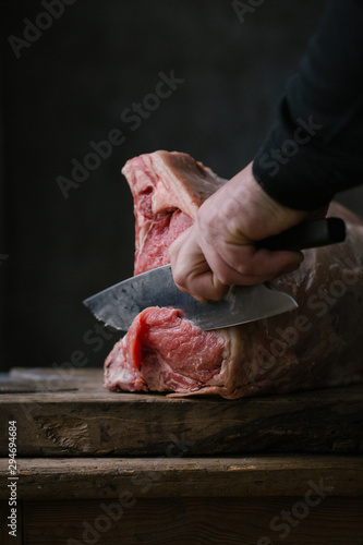 Hand cutting meat with knife