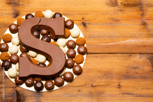 Celebration of Saint Nicholas, patron saint of children in Netherlands, Belgium, Luxembourg and North of France in first week of December, chocolate letters S and ginger cookies photo
