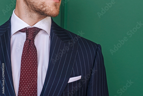 Man wearing pinstripe blazer with spotted tie photo