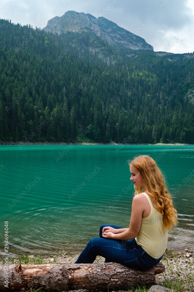 Young teenager girl on Black lake. Montenegro