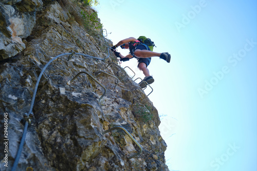 Woman on via ferrata steps at Suncuius, Romania. Adventure concept.