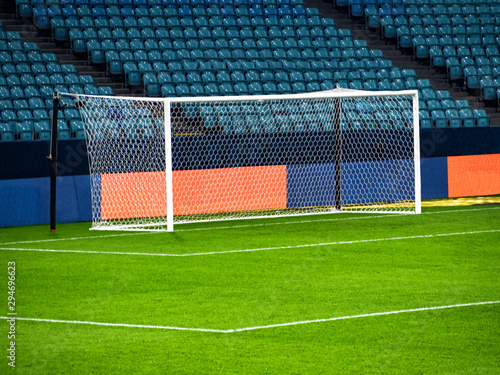 White goal post on football playing arena at empty chairs rows background photo