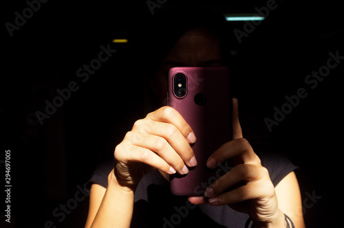 Tourist woman with a smartphone inside Chinese temple, Kuala Lumpur