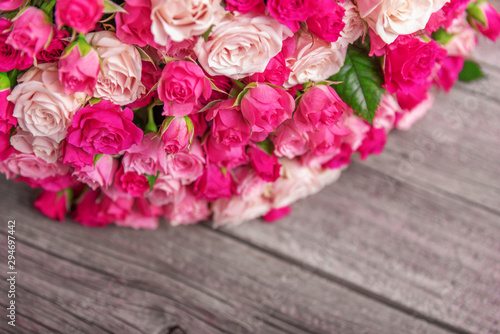 A bouquet of roses on a wooden background.
