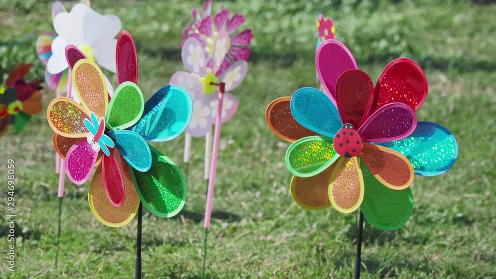 Bright colorful toy windmills are spinning in the wind. Bright colorful toy windmills are spinning in the wind.