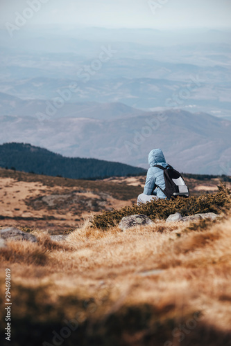 Hiker relaxing on a rock photo