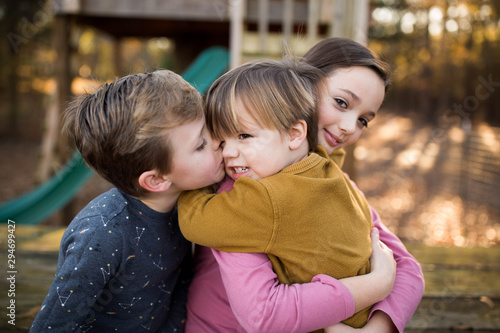 Smiling siblings standing outdoors photo