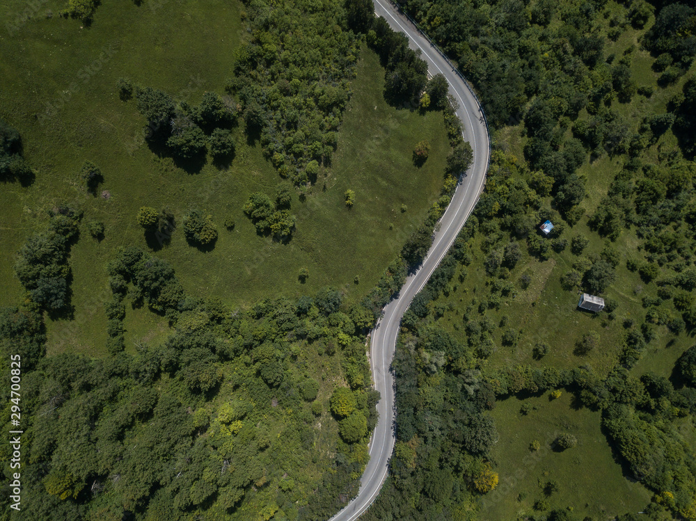 Curvy roadway in green highlands Curvy roadway in green highlands
