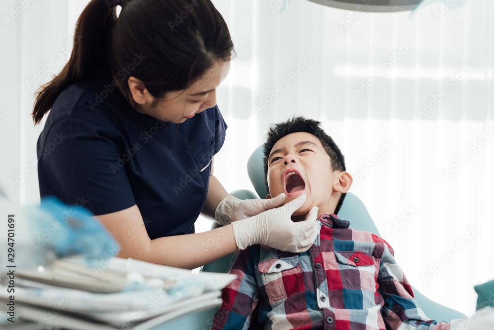 custom made wallpaper toronto digitalFemale dentist examining kids teeth in dentist's office