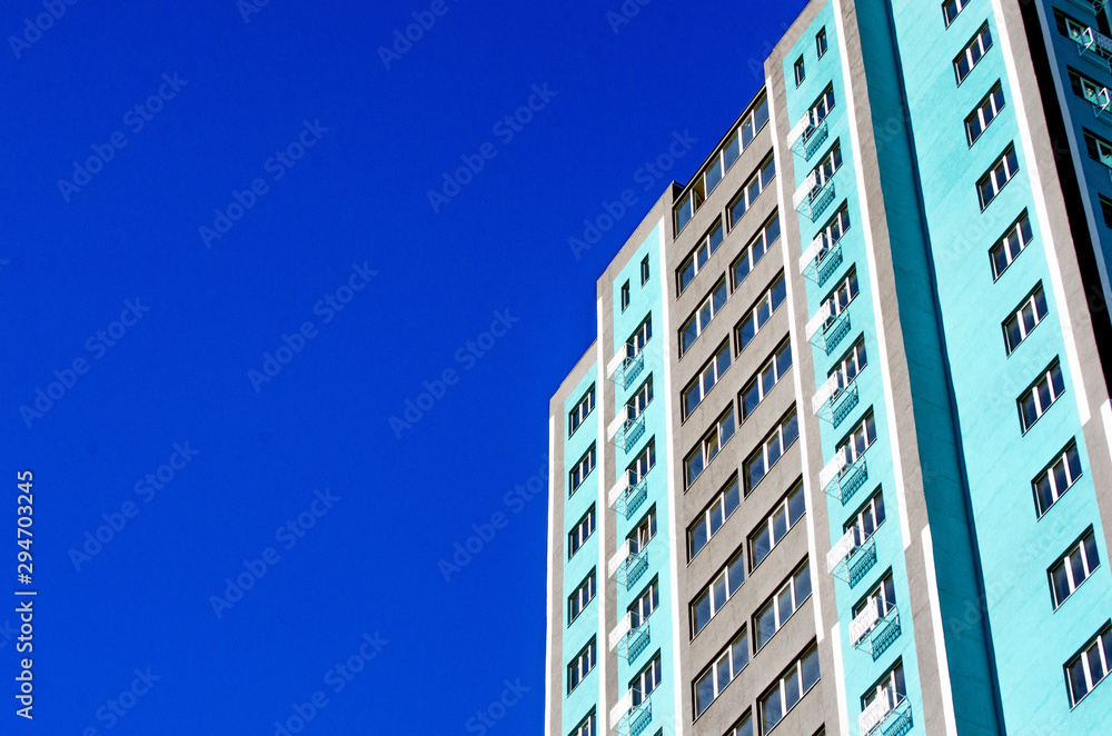 Fototapeta premium New business center ready for opening, building against blue sky, long-term investment concept