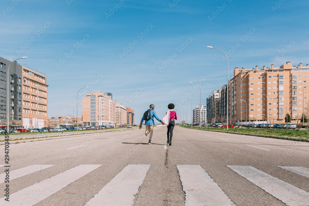 Black couple running along an empty road Black couple running along an empty road