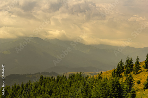 Summer landscape in the Carpathians. Sun through the clouds and fog.