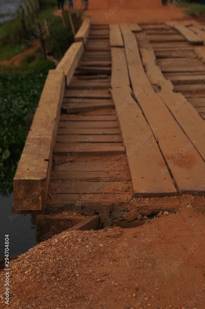 Wooden bridge in perspective. Famous Brazilian Transpantaneira dirt road. Pantanal area, Brazil