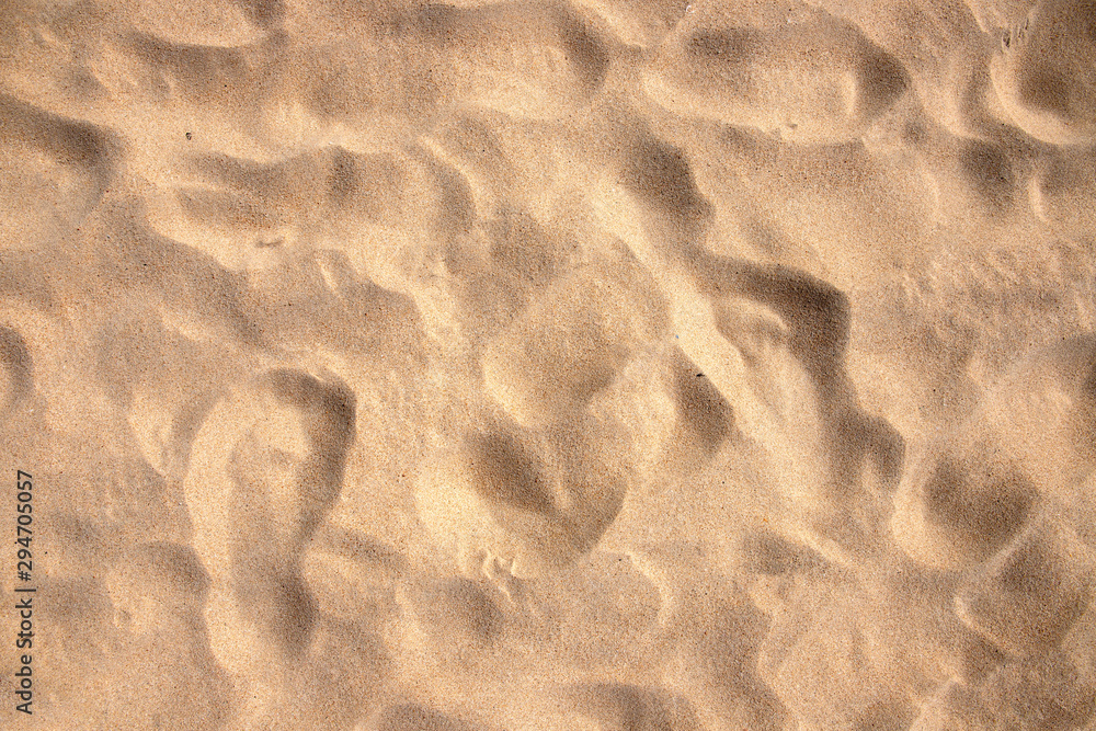 Beach sand texture with step marks, top view photo. Tropical beach banner template. White sand under hot sun Beach sand texture with step marks, top view photo. Tropical beach banner template. White sand under hot sun