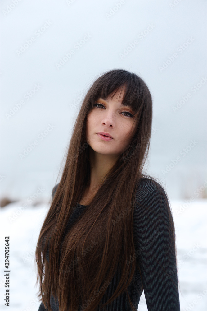 Girl portrait freezing winter. White background. Winter weather. Beauty portrait. Lonely girl winter close-up portrait. Girl portrait freezing winter. White background. Winter weather. Beauty portrait. Lonely girl winter close-up portrait.