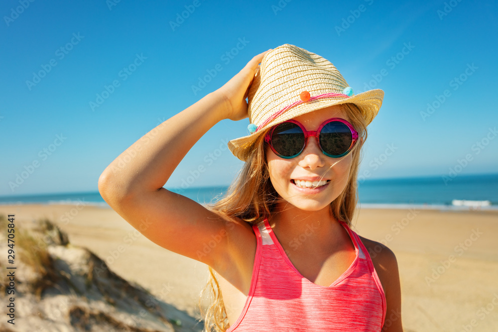 Beautiful girl in sunglasses and holding straw hat Beautiful girl in sunglasses and holding straw hat