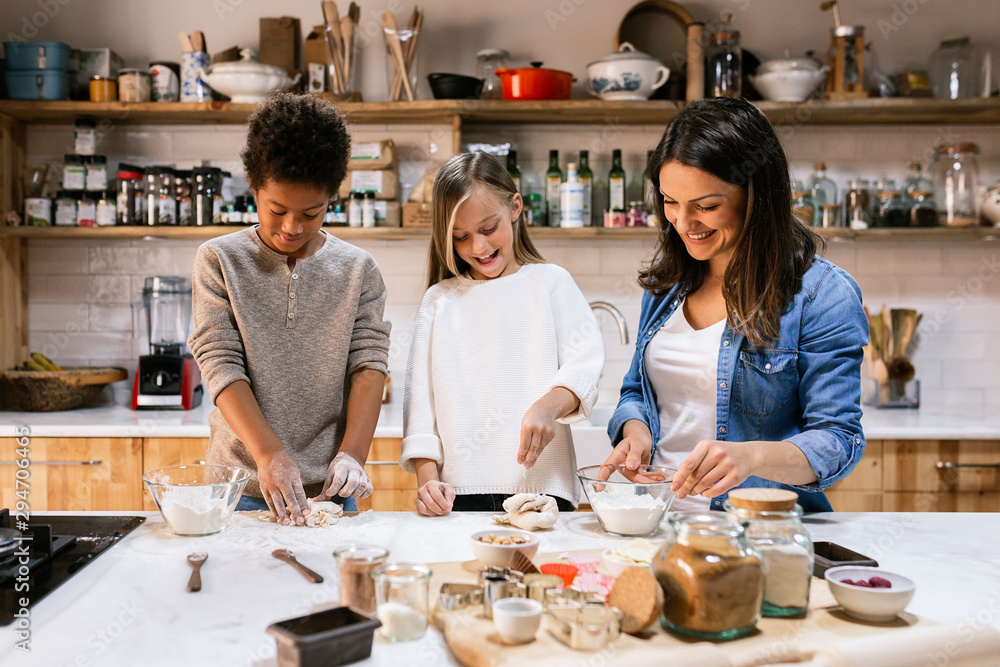Mother near happy children in kitchen Mother near happy children in kitchen