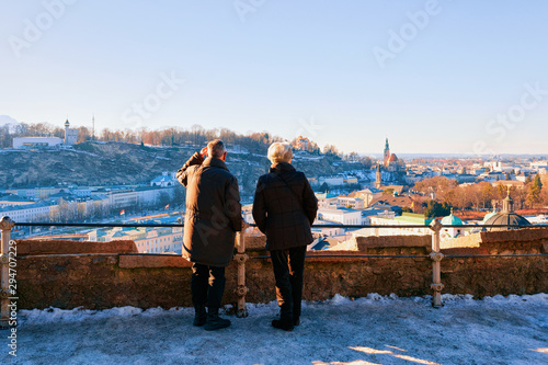 Senior couple looking at Panorama of Salzburg with snow photo