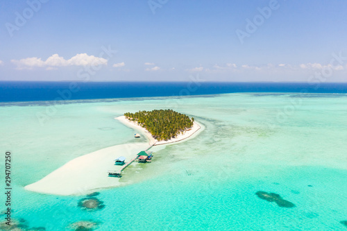 Seascape with a paradise island. Onok Island Balabac, Philippines. A small island with a white sandy beach and bungalows. Philippine Islands.