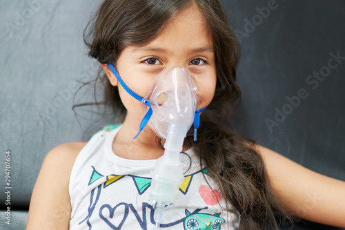 Girl in hospital with respiratory difficulties receiving treatment