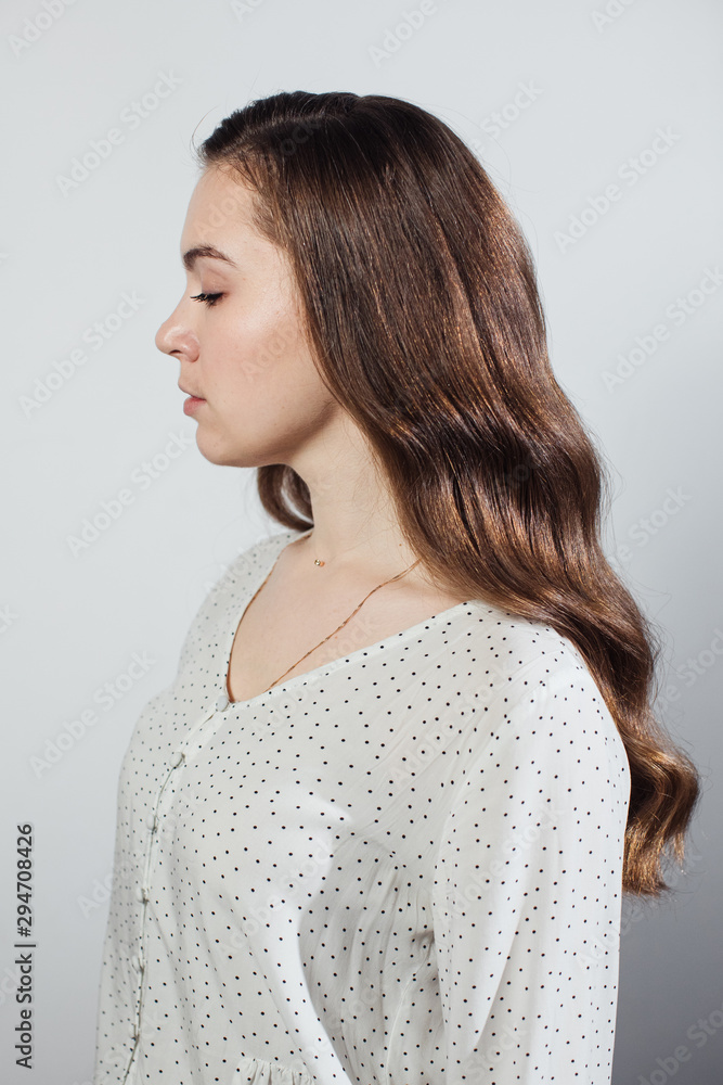Closeup of female hands of hairdresser or coiffeur makes hairstyle. Hair Closeup of female hands of hairdresser or coiffeur makes hairstyle. Hair