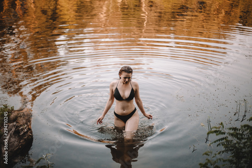 Young woman in bikini walking in lake