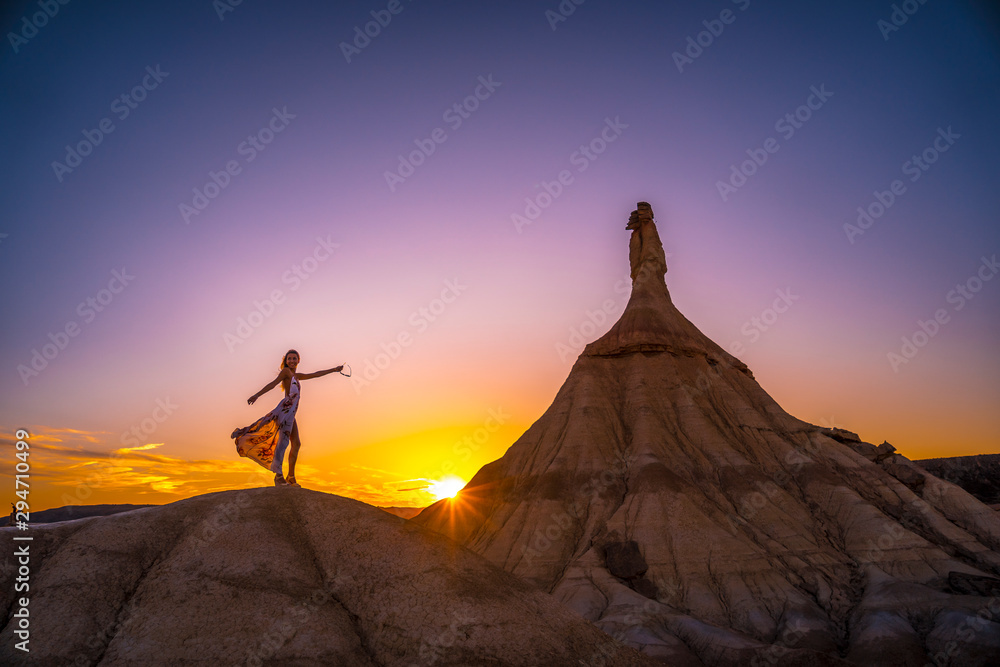 Lifestyle session of a model with a dress at sunset in Las Bardenas, Navarra. Spain