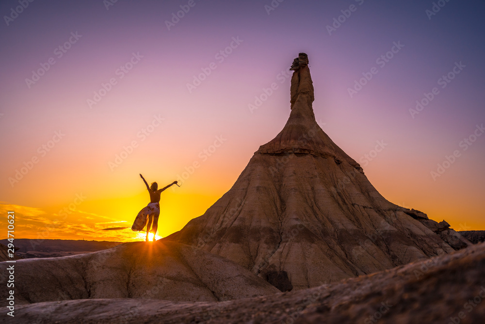 Lifestyle session of a girl in a dress with her arms raised at sunset in Las Bardenas, Navarra. Spain Lifestyle session of a girl in a dress with her arms raised at sunset in Las Bardenas, Navarra. Spain