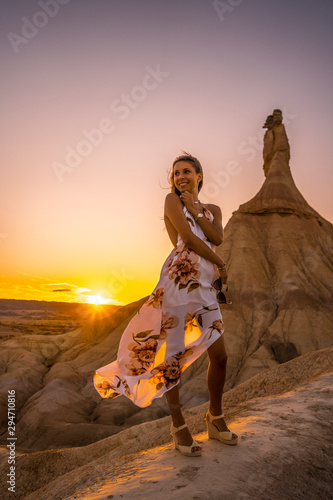 Lifestyle session of a blonde girl with white dress and flowers on a sunset in the Castildestones de las Bardenas. Navarre © unai