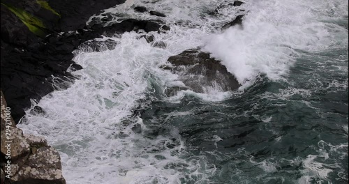 Waves breaking on coastal cliffs of Scotland.
