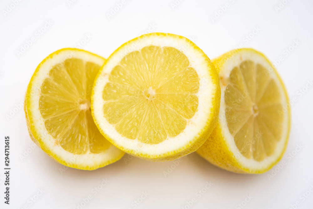 Freshly cut lemon. Sliced lemon on white background. Freshly cut lemon. Sliced lemon on white background.