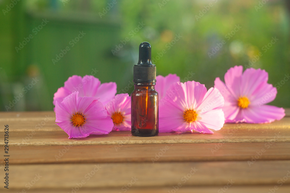 Essence of flowers on table in beautiful glass Bottle Essence of flowers on table in beautiful glass Bottle