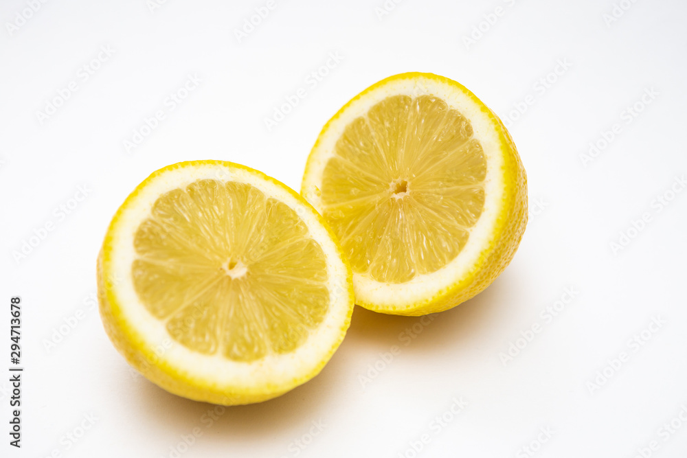 Freshly cut lemon. Sliced lemon on white background. Freshly cut lemon. Sliced lemon on white background.