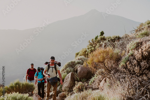 Hikers walking to the top of Guajara Mountain with volcano Teide photo