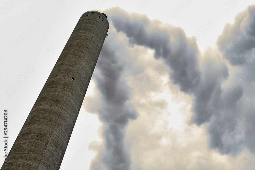 © Cavan Images - Long exposure of smoke coming out of a factory chimney © Cavan Images - Long exposure of smoke coming out of a factory chimney