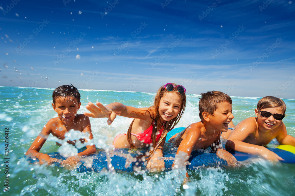 Group of happy kids boy and girls splash in sea Group of happy kids boy and girls splash in sea