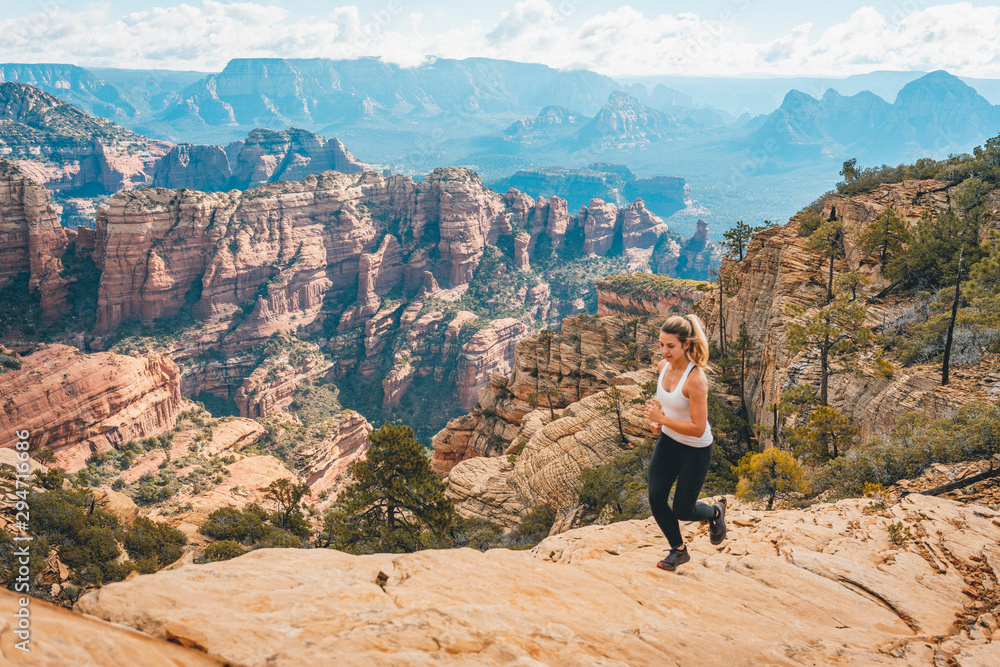 Female trail running Bear Mountain peak, Arizona Female trail running Bear Mountain peak, Arizona