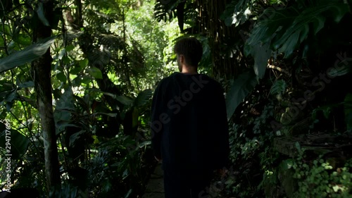 MCU - Following young male model walking through dense jungle in Xilitla, Mexico photo