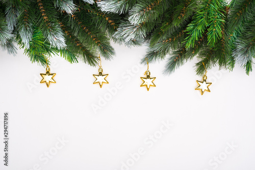 Сhristmas New Year decoration background. Christmas tree branches with gift boxes and Christmas toys laid out on white background. Blank for New Year design.