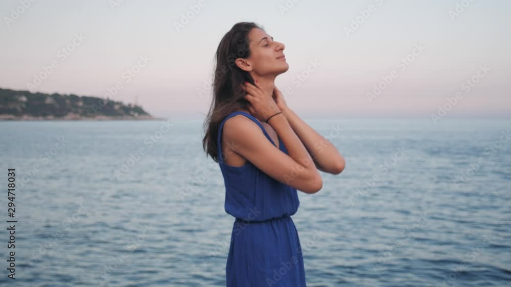 Carefree young woman breathing, smiling and laughing by the sea. Carefree young woman breathing, smiling and laughing by the sea.