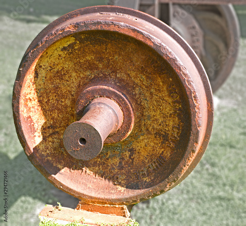The wheel covered with rust from the car of the old railway