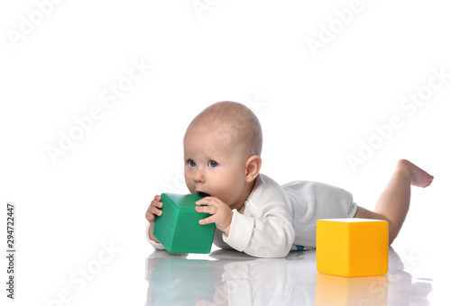 Infant child baby toddler sitting in diaper with green red educational brick toy playing 