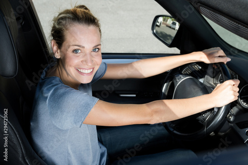 happy woman driver hold car keys in her new car © auremar