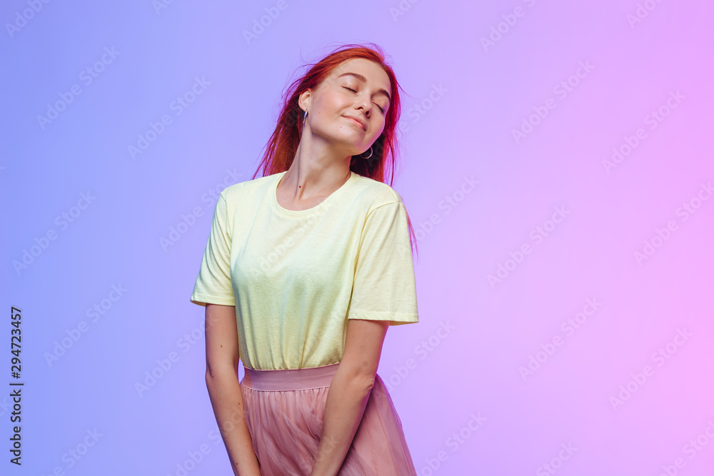 red-haired girl posing on a colored background red-haired girl posing on a colored background