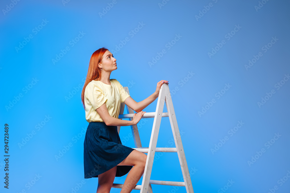 girl stands at the top of the ladder