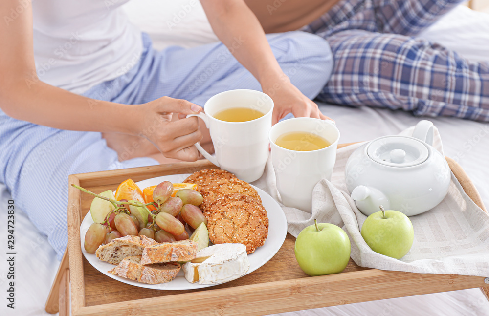 Young couple having breakfast in bed Young couple having breakfast in bed