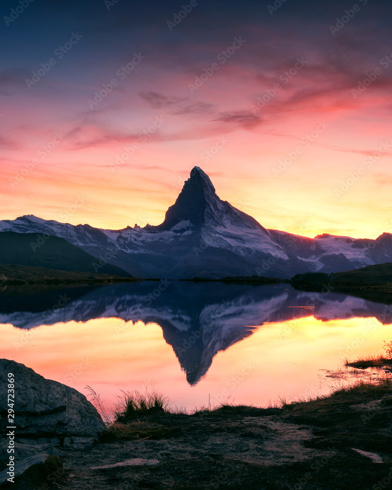 Splendid landscape with colorful sunrise on Stellisee lake with Matterhorn peak on background. Zermatt, Swiss Alps