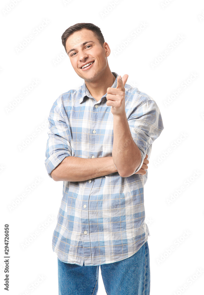 Portrait of handsome young man pointing at viewer on white background Portrait of handsome young man pointing at viewer on white background